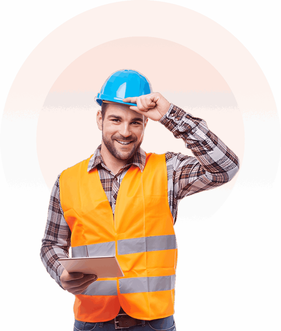 Construction worker in safety gear smiling.