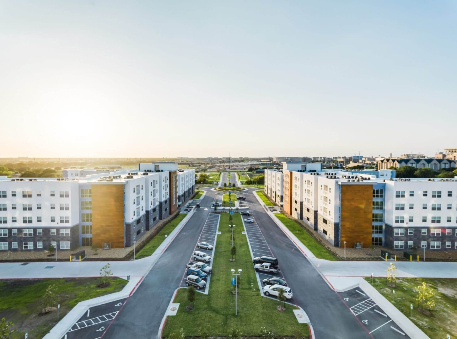 Aerial view of a modern residential area with apartment buildings and green spaces.