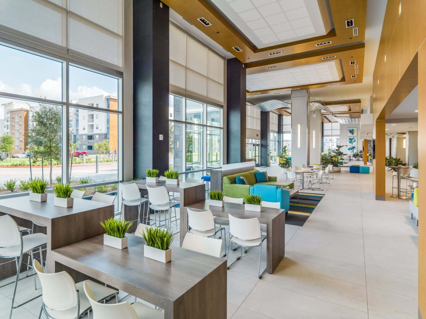 Bright modern office space with large windows and comfortable seating.