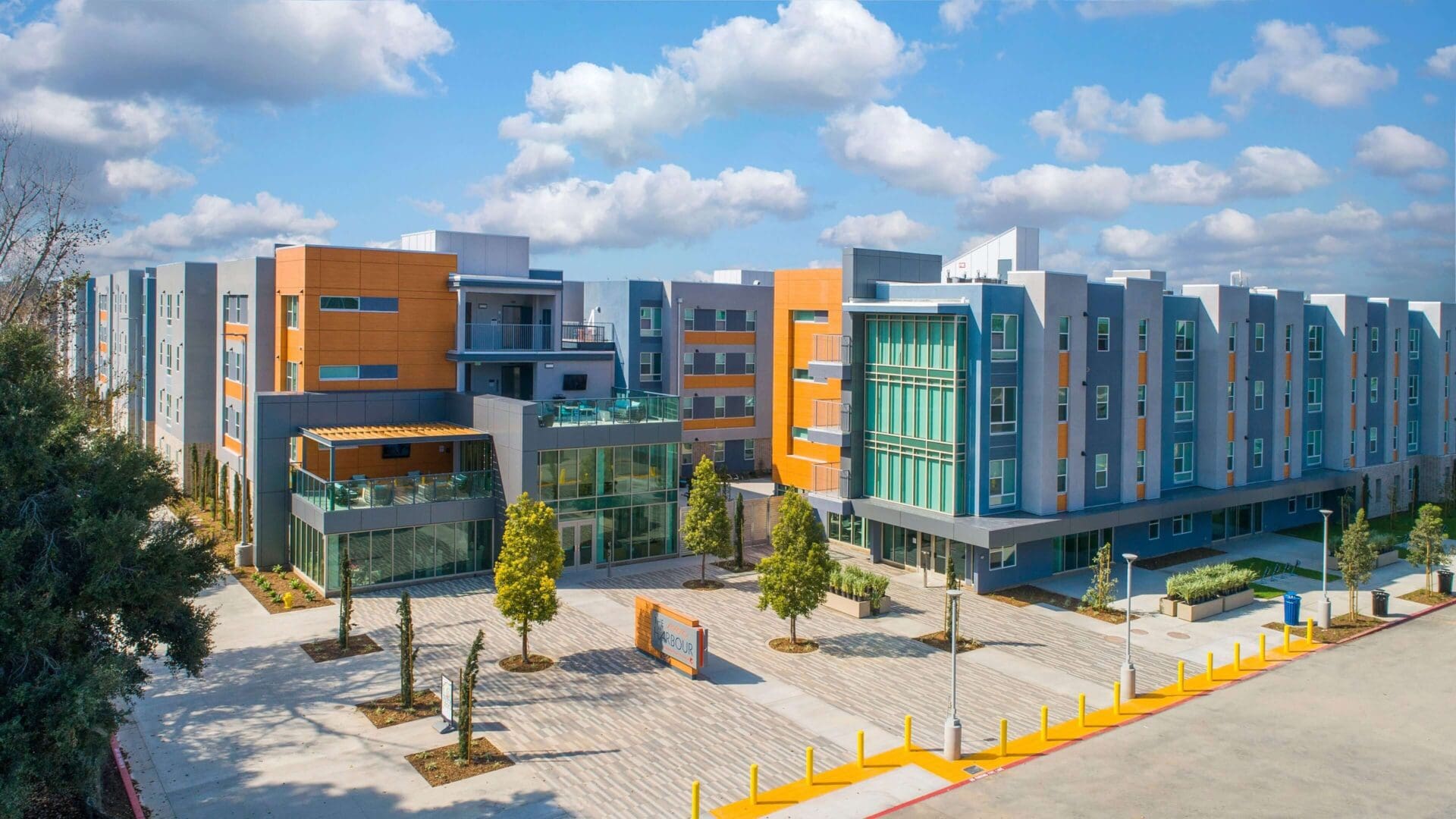 Modern school campus with colorful buildings and open courtyard.