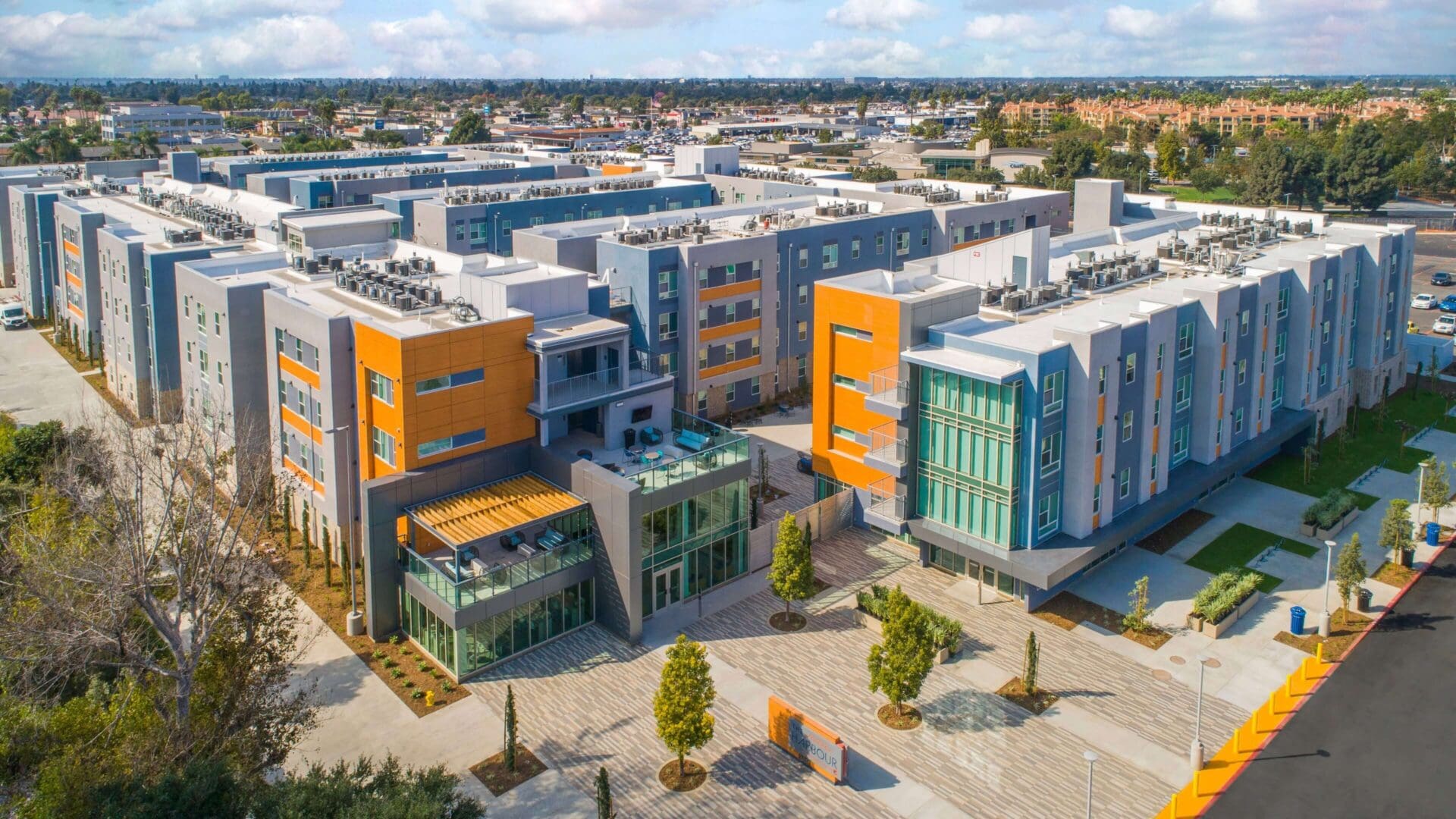 Modern educational campus with colorful buildings and open courtyard.