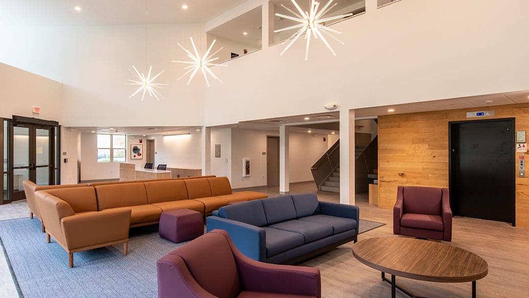 Modern living room with stylish sofas and bright pendant lights.