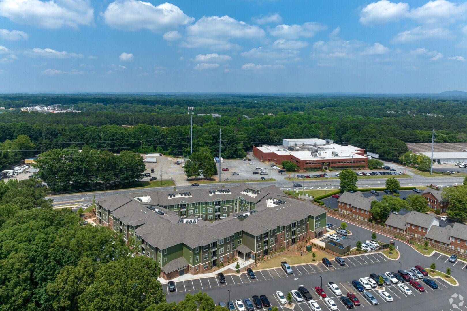 Aerial view of a suburban shopping center on a sunny day.